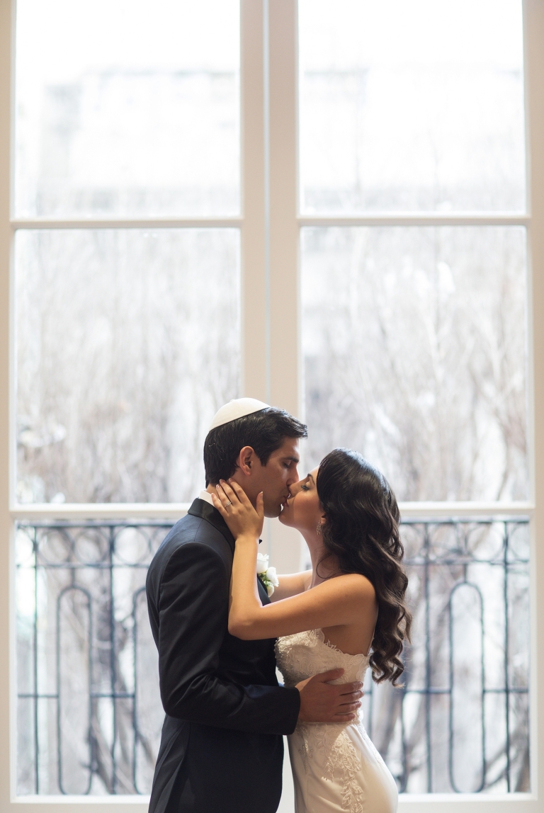 Tender bride + groom kiss | Alexandria Ballrooms